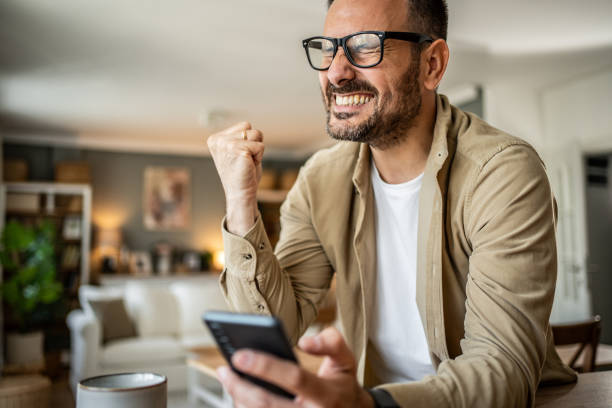 istock Portrait of a middle-aged man using a smartphone at home 2157244145