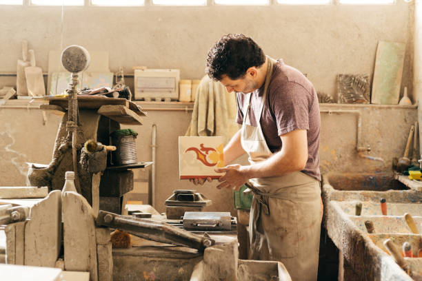 istock Skilled Worker Creating Decorative Cement Tiles in a Factory During the Day 2157244331