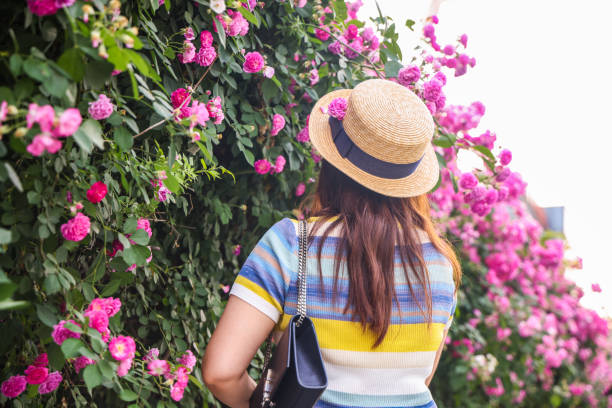 Woman posing near blooming roses