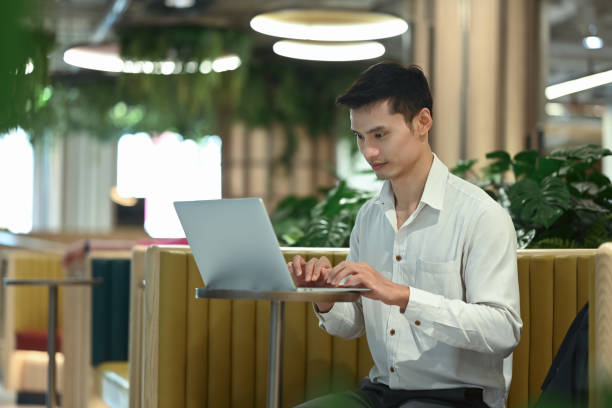 istock Handsome businessman working with laptop in modern coworking space 2157246592