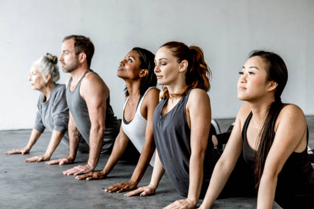 istock Diverse people in a Bhujangasana pose 2157247315