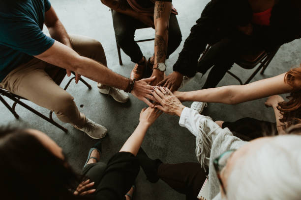 istock Group of diverse team joining hand in the middle 2157247357