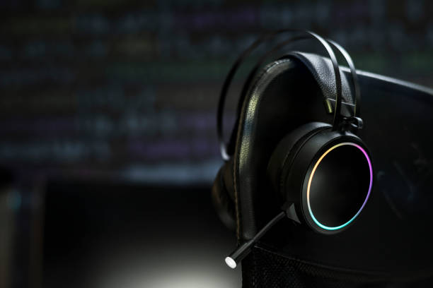 istock Black headphones in the dark room 2157247443