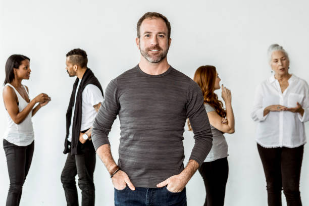 Confident man standing in front of his team