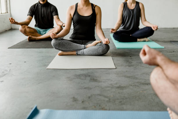 istock People meditating in a yoga class 2157248438