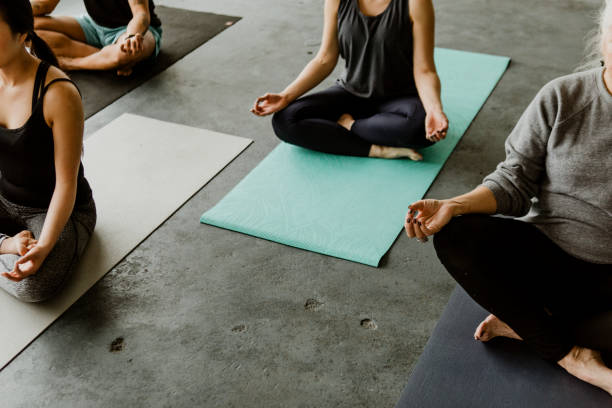 istock People meditating in a yoga class 2157248457
