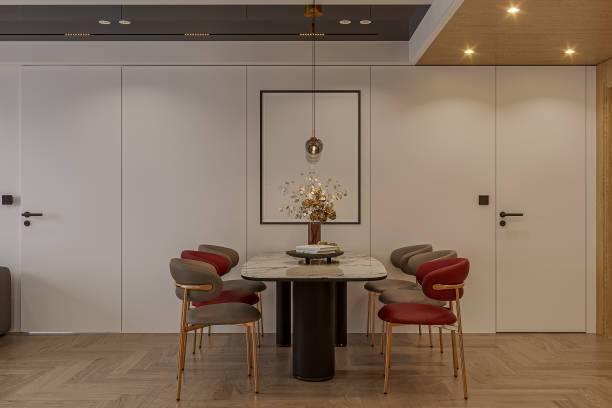 istock Modern dining room interior design with red and gray chairs, white table with black stand. 2157248939