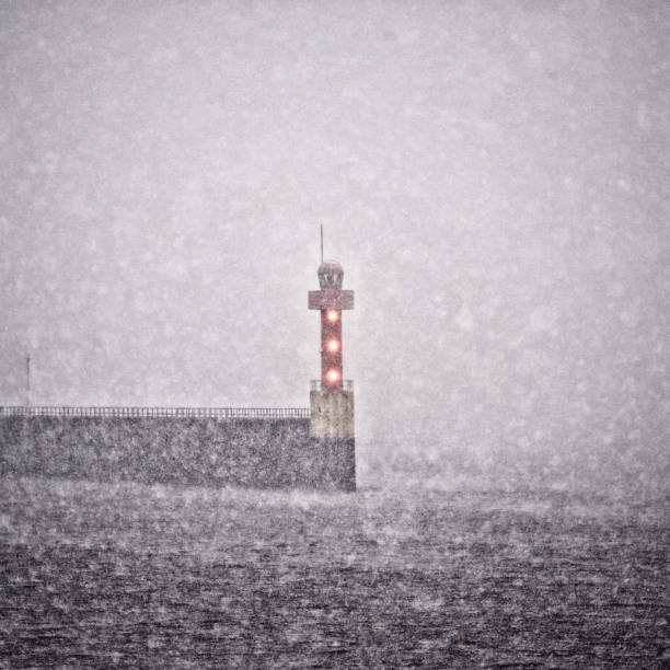 small red flashing lighthouse in a snowstorm