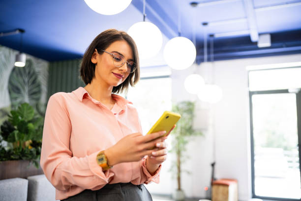 istock Young Caucasian businesswoman using mobile phone at the office 2157249557
