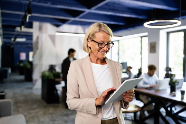 istock Caucasian senior businesswoman using digital tablet at the office 2157249768