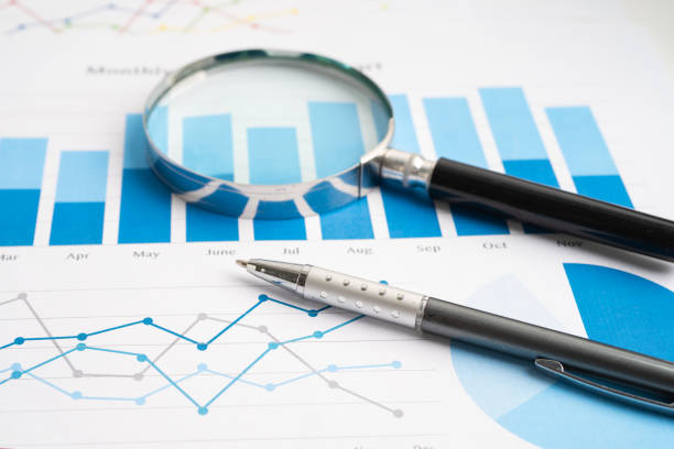 istock Magnifying glass on spreadsheet and graph paper. Financial development, Banking Account, Statistic, Investment Analytic research data economy, Business. 2157250453
