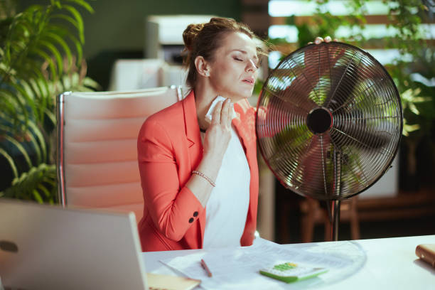 istock 40 years old woman worker at work suffer from heat 2157250553