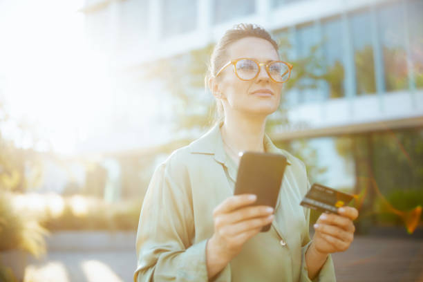 istock pensive modern female worker in green blouse and eyeglasses 2157251065