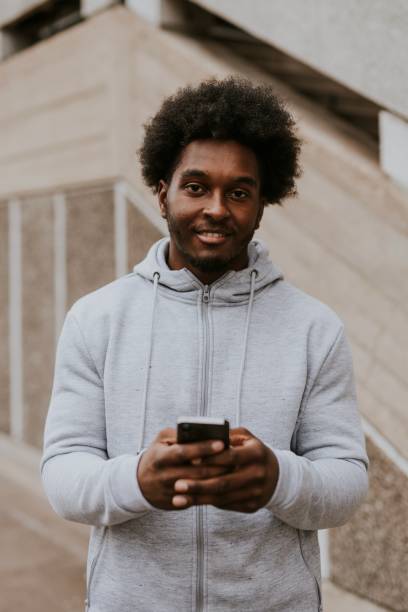 istock Man in gray hoodie using phone 2157251184