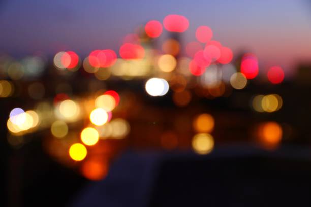Big city night lights - defocused evening skyline of London UK. Blurry cityscape.