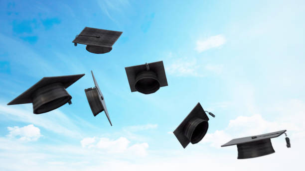 istock Six Graduation Caps Soaring Against a Blue Sky 2157253028