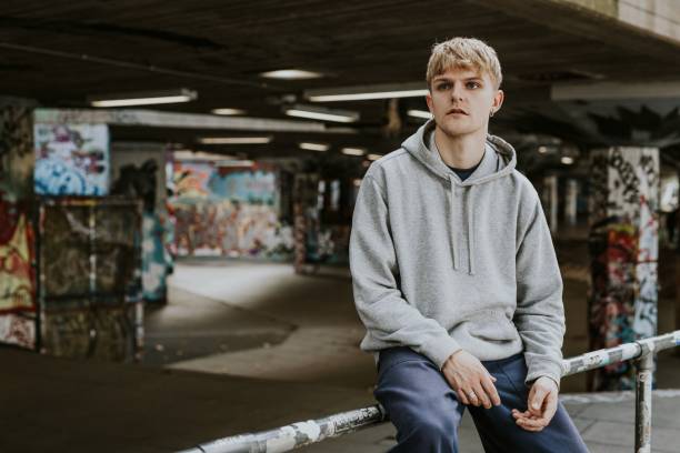 istock Blond man in gray hoodie at skate park 2157253100