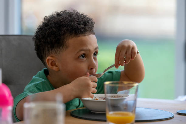 istock Boy Eating Spoonful of Cereal 2157253315