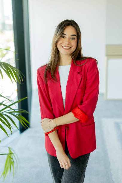 istock Confident woman smiling in bright office space during daytime 2157253364