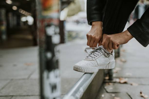 istock Man tying shoelaces on street railing 2157253374
