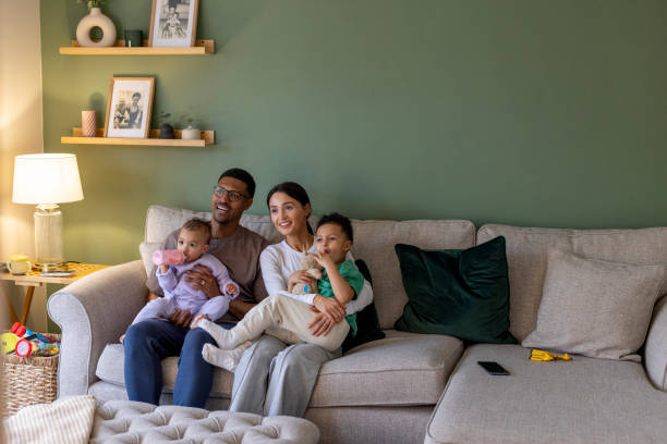 istock Happy Family Embracing on the Sofa 2157253443