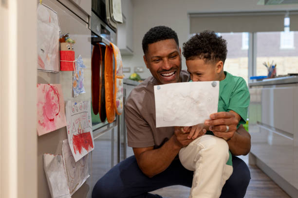 istock Happy Father and Son Looking at Drawing 2157253718