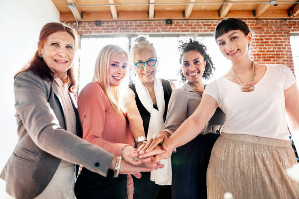 istock Women joining hands in the middle 2157254027