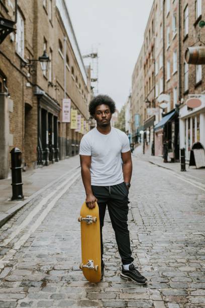 Man in city with yellow skateboard