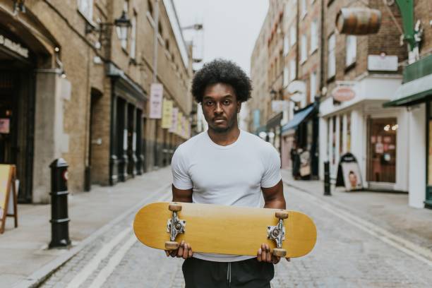 istock Man with wooden skateboard in town 2157254132