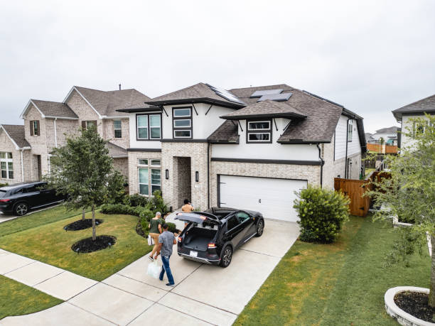 istock Family Returning Home with EV and Solar Panels on Roof 2157254381