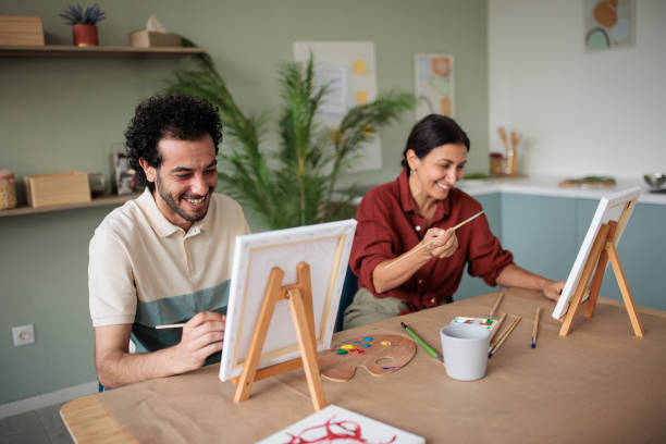 istock Two friends painting together at home 2157255402