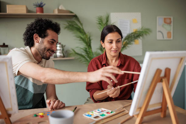 istock Two friends painting together at home 2157255405