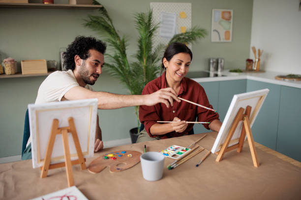 istock Two friends painting together at home 2157255492