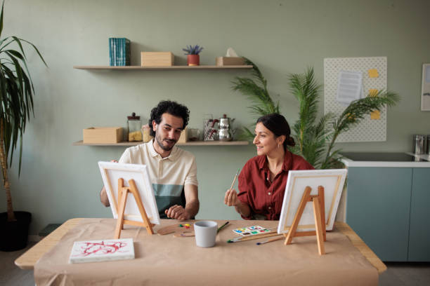 istock Two friends painting together at home 2157255493