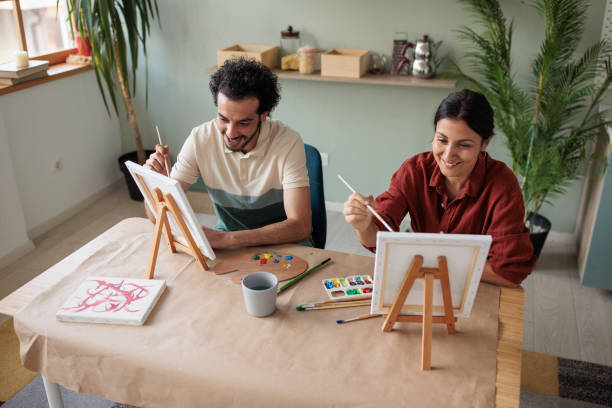 istock Two friends painting together at home 2157255527