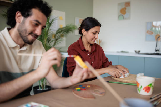 istock Two friends making clay bowls at home 2157255578