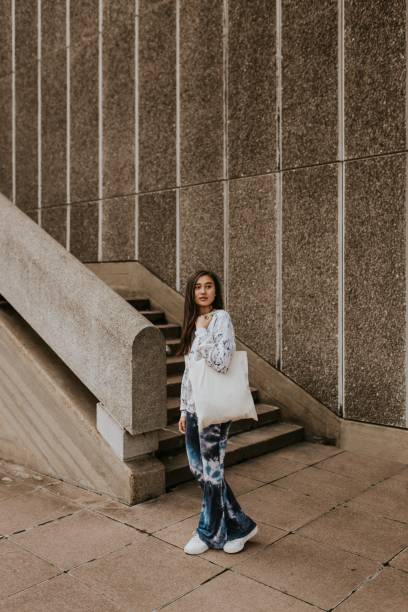 istock Woman in blue tied dye pants, using white tote bag 2157255610