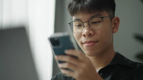 istock Teenager talking with voice assistant on smartphone. 2157255628