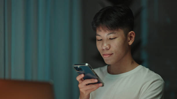 istock Teenager student talking with a voice assistant on smartphone at night. 2157256736