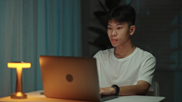 istock Teenager using laptop at night. 2157256848