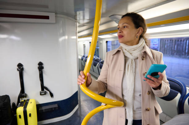 istock Woman using smartphone while traveling on a train with luggage 2157257111