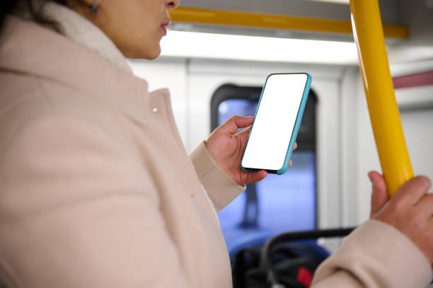 istock Woman holding smartphone with blank screen while commuting on public transport 2157257150