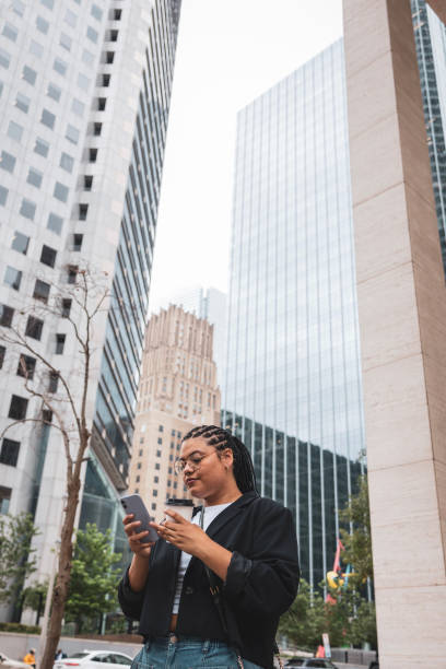 istock Low angle photo of woman using mobile phone 2157258440