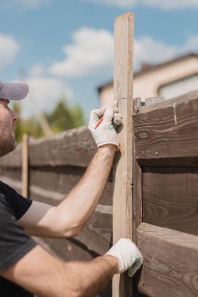 istock A man builds a wooden fence from boards 2157259845