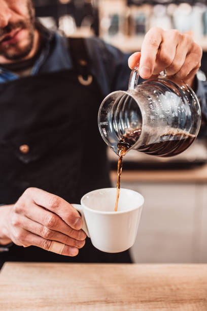 istock A man professionally brews coffee in a glass teapot 2157259910