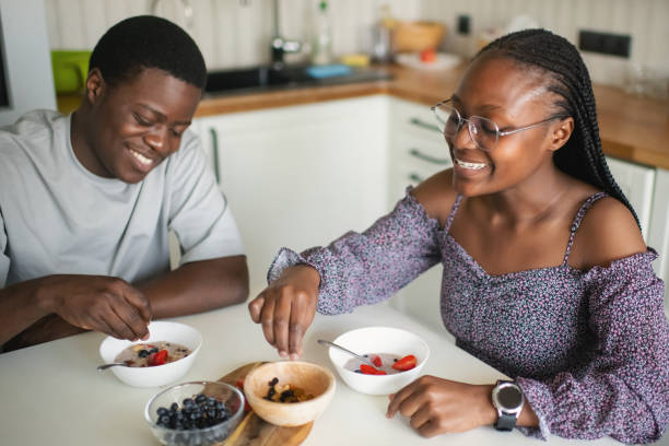 istock Happy couple having breakfast in the morning at the kitchen 2157264596