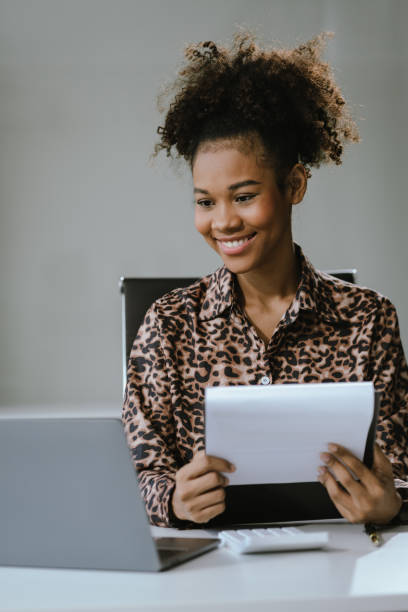istock Businesswomen hand working with tablet and laptop computer with documents on office desk in modern office. 2157266297