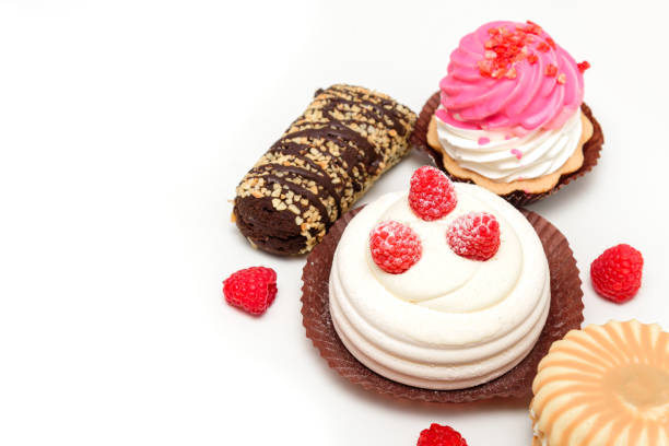 group of cakes and biscuits in a plate with a white background