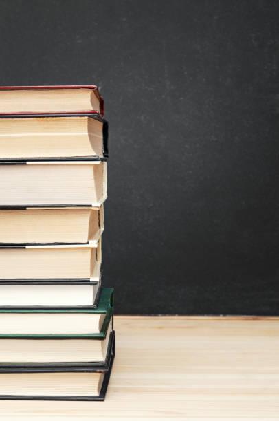 istock Stack of books in front of black chalkboard 2157269344