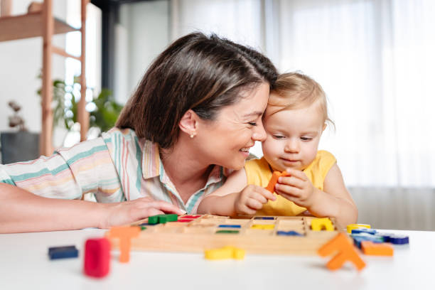 istock Young mother is playing with her young toddler daughter at home 2157271237